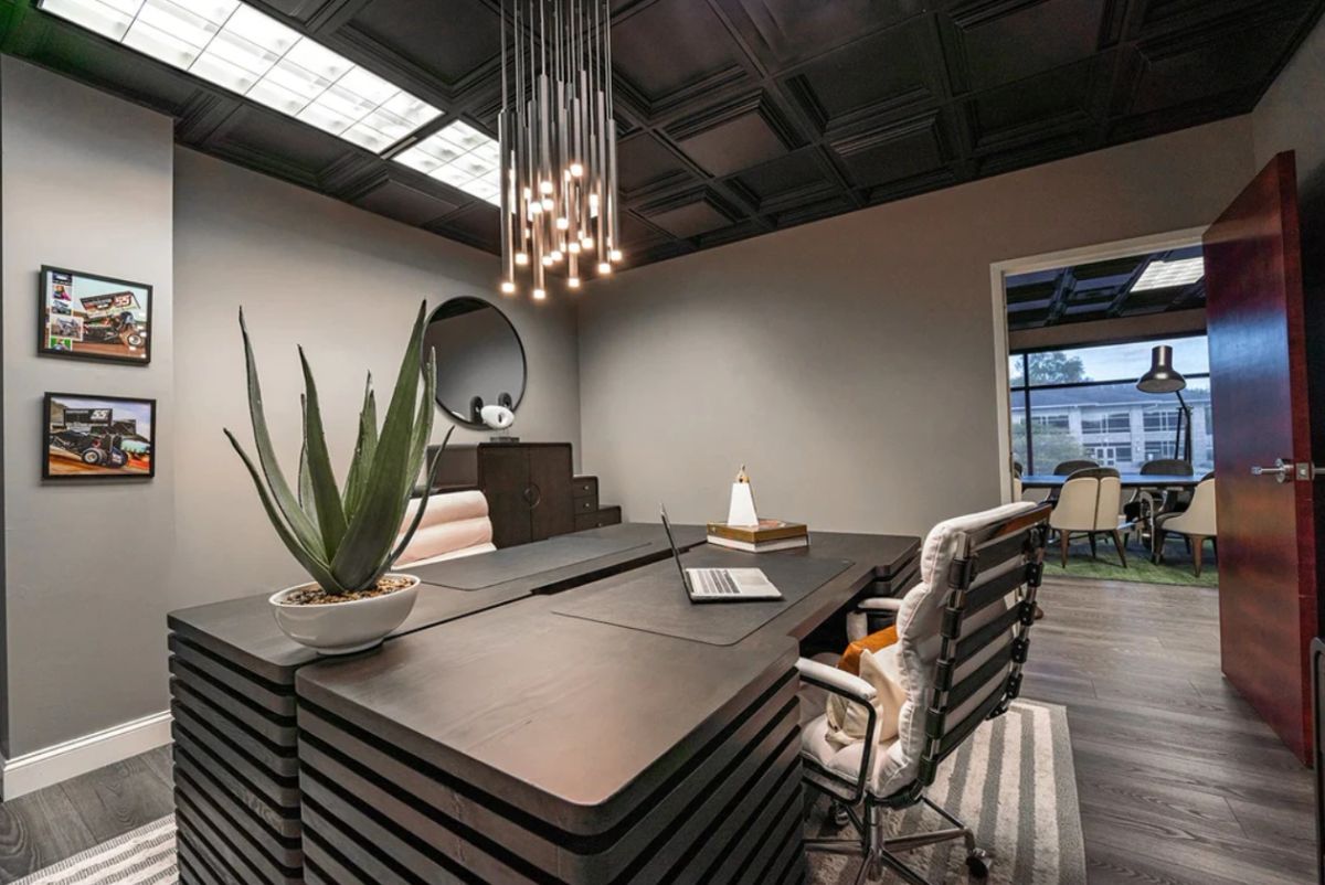 A study designed by Daniel Home with a dark timber desk and layered task lighting